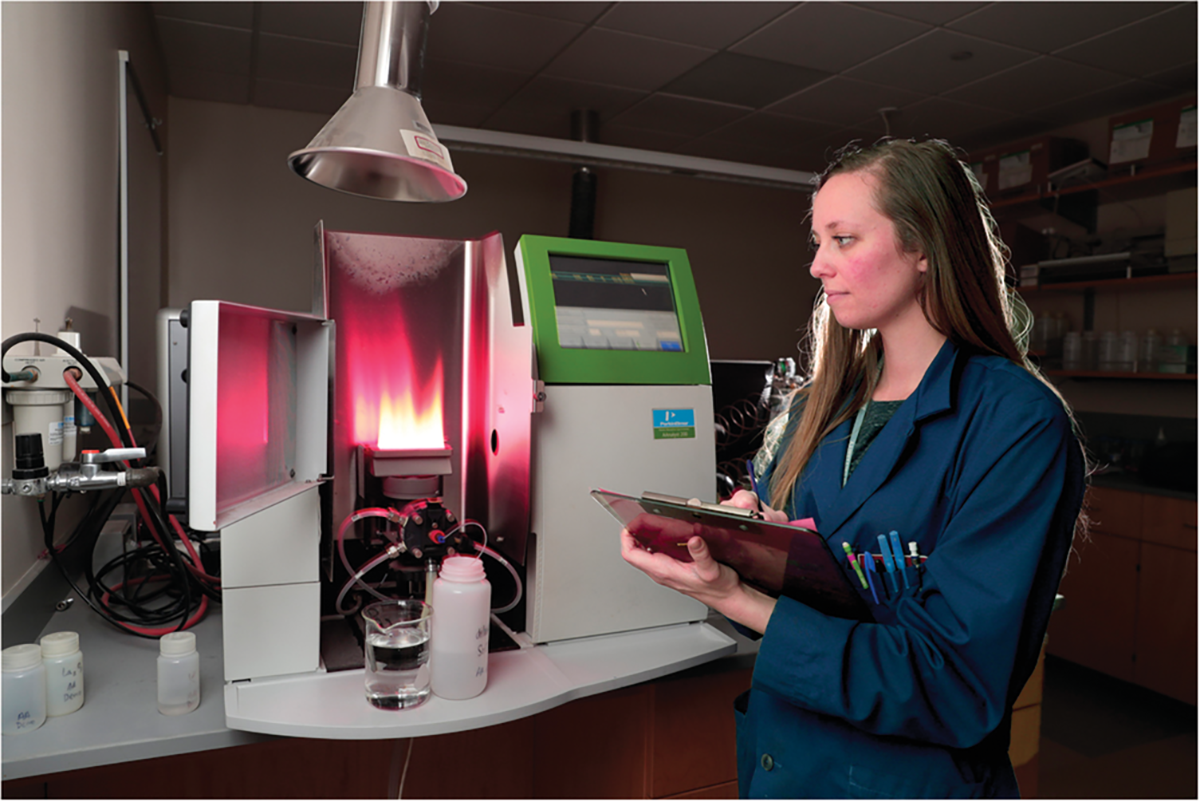 Analyses need to be accurate and precise as done by trained, professional personnel in a laboratory with excellent quality assurance/quality control. Pictured here is Rachel Buck, Laboratory Manager of the BYU Environmental Analytical Laboratory, using an atomic adsorption spectrophotometer for soil analysis. Source: BYU Photography.
