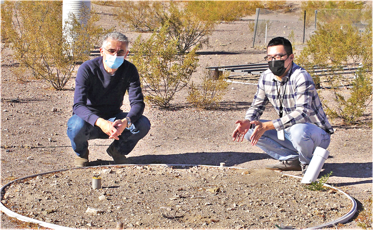 Drs. Yuan Luo (right) and Markus Berli (left) discussing the soil surface of SEPHAS Lysimeter 1 at the Desert Research Institute in Boulder City, NV. Photo by Ali Swallow, Desert Research Institute.