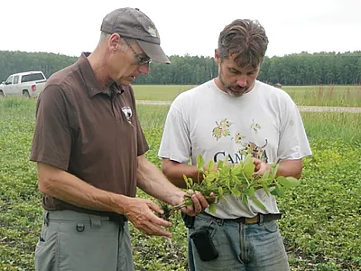 CCA John Heard (left) working with a grower.