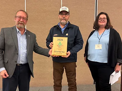 Mark McClintic (center) was named Michigan's first CCA of the Year in January 2026. On his left is Tim Schaub, Michigan CCA Board Chair, and on his right is Lara Bryant, Associate Director of Component Relations for the American Society of Agronomy. 