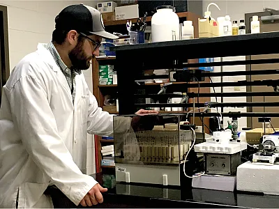 Lead author Josh Padilla monitors a sorption kinetics experiment like those done in this study. Photo by Easton Padilla.